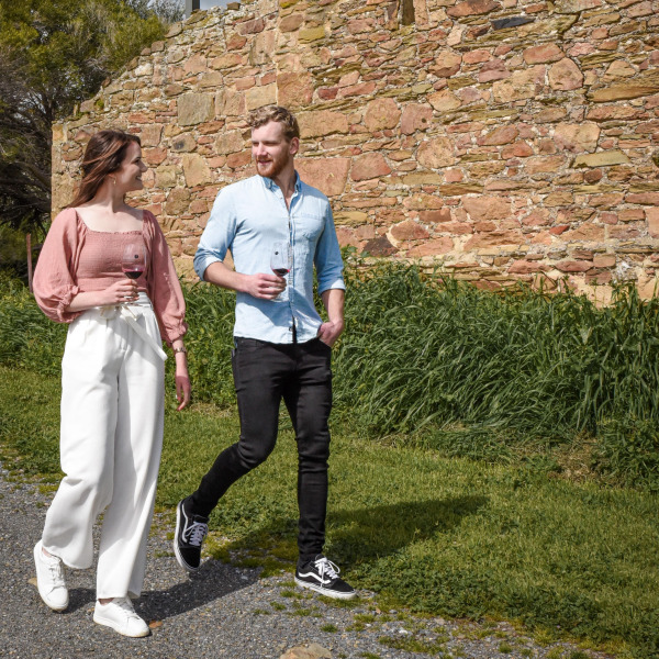 Couple walking through the historic grounds of Battle of Bosworth wines